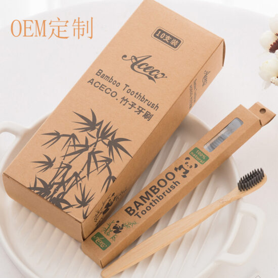 Bamboo toothbrush with wooden bamboo handle and charcoal bristles for hotels and guesthouses
