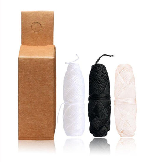 Mint-flavored charcoal and corn fiber dental floss in glass bottle with kraft box