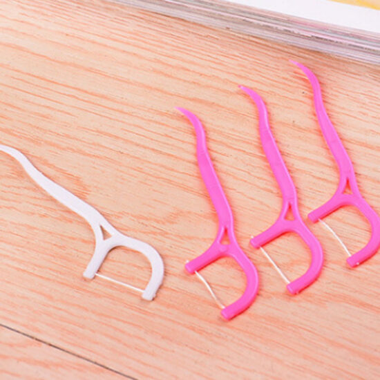 Plastic bag packed disposable dental floss picks for oral hygiene and interdental cleaning