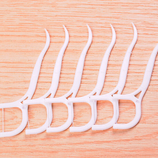 Plastic bag packed disposable dental floss picks for oral hygiene and interdental cleaning