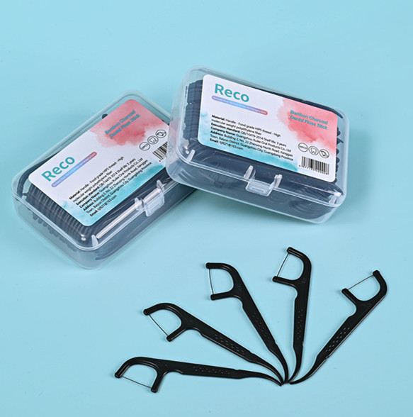 Bamboo charcoal floss picks for oral hygiene in plastic box packaging