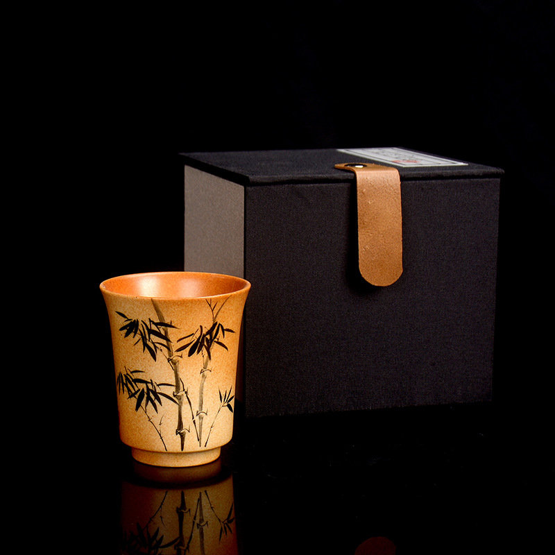 Handmade wood-fired ceramic tea cup with bamboo bell shape and brushwork